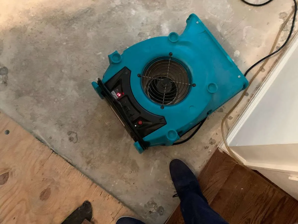 Air mover drying subfloor during Commercial Water Damage Restoration in Foster City